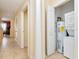 Convenient laundry area featuring a washer, dryer, and water heater, with easy access from the hallway at 13941 Clubhouse Dr # 308, Tampa, FL 33618