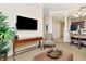 Bright living room boasting a flat screen TV, comfortable chair, and a dining area visible in the background at 13941 Clubhouse Dr # 308, Tampa, FL 33618