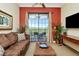 Comfortable living room with a balcony offering natural light and outdoor views at 13941 Clubhouse Dr # 308, Tampa, FL 33618