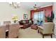 Comfortable living room featuring a ceiling fan, seating, large windows, and access to outdoor balcony at 13941 Clubhouse Dr # 308, Tampa, FL 33618