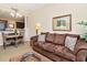 Cozy living room with brown sofa, dining table and chairs, decorative pillows and light fixture at 13941 Clubhouse Dr # 308, Tampa, FL 33618