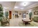 Welcoming lobby area with comfortable seating, plants, and easy access to elevators at 13941 Clubhouse Dr # 308, Tampa, FL 33618