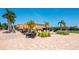 View of the attractive pool area with seating, umbrellas, and lush tropical landscaping at this beautiful community at 13941 Clubhouse Dr # 308, Tampa, FL 33618