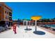 Colorful splash pad with multiple water features and poolside loungers for sunny enjoyment at 13941 Clubhouse Dr # 308, Tampa, FL 33618
