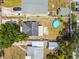 Aerial view of the property featuring a backyard with a blue circular swimming pool, patio seating, and mature landscaping at 1420 W Rambla St, Tampa, FL 33612