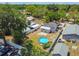 Backyard view features privacy fence, mature trees, seating area, and an above ground pool with an assortment of pool toys at 1420 W Rambla St, Tampa, FL 33612