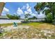 Spacious backyard featuring a small above ground pool, partial white fencing and a blue Adirondack chair at 1420 W Rambla St, Tampa, FL 33612