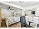 This bedroom has a ceiling fan, tv, and furniture including a dresser with mirror and a chair at 1420 W Rambla St, Tampa, FL 33612