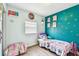 bedroom featuring a colorful accent wall, pink bed frame, and hardwood floors at 1420 W Rambla St, Tampa, FL 33612
