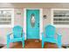 Close up of front door with blue chairs on the front porch at 1420 W Rambla St, Tampa, FL 33612