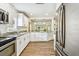 Spacious kitchen featuring granite countertops, stainless steel fridge, and a seamless flow to living spaces at 1420 W Rambla St, Tampa, FL 33612