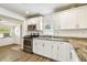Bright kitchen with white cabinets, stainless steel appliances, and granite countertops at 1420 W Rambla St, Tampa, FL 33612