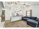 Open-concept living room with hardwood floors, ceiling fans, and a view into the kitchen at 1420 W Rambla St, Tampa, FL 33612