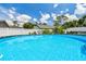 Close-up view of an above-ground pool with a blue patterned interior, ladder and white fencing at 1420 W Rambla St, Tampa, FL 33612