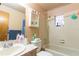 Neutral-toned bathroom featuring a shower-tub combo and ample counter space at 1512 W Sitka St, Tampa, FL 33604