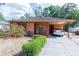 Charming single-story home with an attached covered carport and well-maintained front yard landscaping at 1512 W Sitka St, Tampa, FL 33604