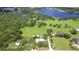 Stunning aerial view of the property, highlighting the home, pool, surrounding land, and a nearby lake at 16930 Sweetwater Rd, Dade City, FL 33523