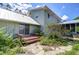 Scenic backyard with wooden deck and lush garden featuring thriving vegetation and a stone patio at 16930 Sweetwater Rd, Dade City, FL 33523