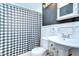 Cozy bathroom with patterned shower curtain, pedestal sink, and toilet at 16930 Sweetwater Rd, Dade City, FL 33523