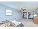 Spacious bedroom with neutral carpet, two closets, a ceiling fan, and a large window at 16930 Sweetwater Rd, Dade City, FL 33523