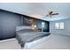 Bedroom with dark accent wall and fan at 16930 Sweetwater Rd, Dade City, FL 33523