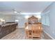 Open dining room with a wood table and chairs next to a living room with a leather sofa at 16930 Sweetwater Rd, Dade City, FL 33523