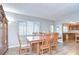 Dining room area featuring a table with six chairs and a view into the kitchen at 16930 Sweetwater Rd, Dade City, FL 33523