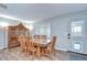 Dining room area featuring a table with six chairs and a view into the kitchen at 16930 Sweetwater Rd, Dade City, FL 33523