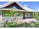 Craftsman-style home featuring stone accents, lush landscaping, and a cozy front porch at 16930 Sweetwater Rd, Dade City, FL 33523