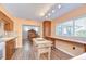 Eat-in kitchen features a large window, wood cabinets, and an island at 16930 Sweetwater Rd, Dade City, FL 33523