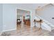 Open living room with wood-look flooring and a staircase at 16930 Sweetwater Rd, Dade City, FL 33523