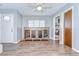 Cozy living room with stylish hardwood floors, ceiling fan, and a bright, airy atmosphere at 16930 Sweetwater Rd, Dade City, FL 33523