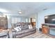 Comfortable living room with wood floors, a ceiling fan, and a view into the dining area at 16930 Sweetwater Rd, Dade City, FL 33523