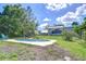 Backyard pool features a patio and a home with a screened-in back porch at 16930 Sweetwater Rd, Dade City, FL 33523