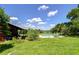 Backyard pool features lounge chairs, a green lawn, and serene landscape views at 16930 Sweetwater Rd, Dade City, FL 33523