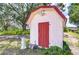 Quaint red and white garden shed featuring a classic design at 16930 Sweetwater Rd, Dade City, FL 33523