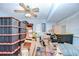 Functional storage room featuring ample shelving and a ceiling fan for ventilation at 16930 Sweetwater Rd, Dade City, FL 33523