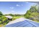Scenic view from the rooftop, featuring fields, trees, and distant rooftops at 16930 Sweetwater Rd, Dade City, FL 33523
