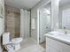 Clean bathroom featuring a shower with neutral tile, white cabinets, and updated fixtures at 1701 Pinehurst Rd # 16C, Dunedin, FL 34698