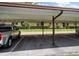 View of the covered parking area and landscaping of the complex at 1701 Pinehurst Rd # 16C, Dunedin, FL 34698