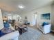Bright living room with a modern coffee table, cozy seating, and an open floor plan at 1701 Pinehurst Rd # 16C, Dunedin, FL 34698