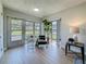 Bright sunroom featuring a comfortable chair, large windows, and wood flooring at 1701 Pinehurst Rd # 16C, Dunedin, FL 34698