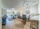 Cozy living space with wood floors, decorative lighting, modern furniture, and kitchen view at 1701 Pinehurst Rd # 16C, Dunedin, FL 34698