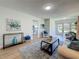 Bright and airy living room with wood floors, modern decor, and seamless transition to outdoor living at 1701 Pinehurst Rd # 16C, Dunedin, FL 34698