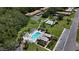 Aerial view of a community pool, surrounded by lounge chairs and lush landscaping in a well-maintained complex at 1701 Pinehurst Rd # 16C, Dunedin, FL 34698