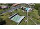 Aerial view of shuffleboard courts in a complex setting, with pool and low-rise residential buildings at 1701 Pinehurst Rd # 16C, Dunedin, FL 34698