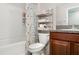 Tastefully designed bathroom with a tub, floral shower curtain, and dark wood vanity at 17334 White Mangrove Dr, Wimauma, FL 33598
