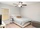 Comfortable bedroom featuring a window, ceiling fan and neutral tones at 17334 White Mangrove Dr, Wimauma, FL 33598