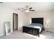 Spacious main bedroom featuring neutral tones, a ceiling fan, and soft carpeting at 17334 White Mangrove Dr, Wimauma, FL 33598