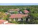 Aerial view of condos, assigned parking, and lush tree coverage at 1801 E Lake Rd # 3A, Palm Harbor, FL 34685
